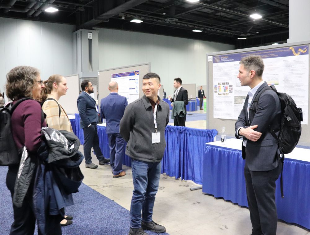 Cheng-Kai Hsu presents poster to Julia Griswold and Robert Schneider