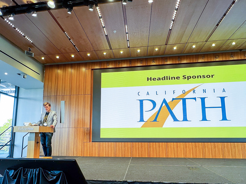Speaker welcoming crowd to PATH sponsored Haas Mobility Summit