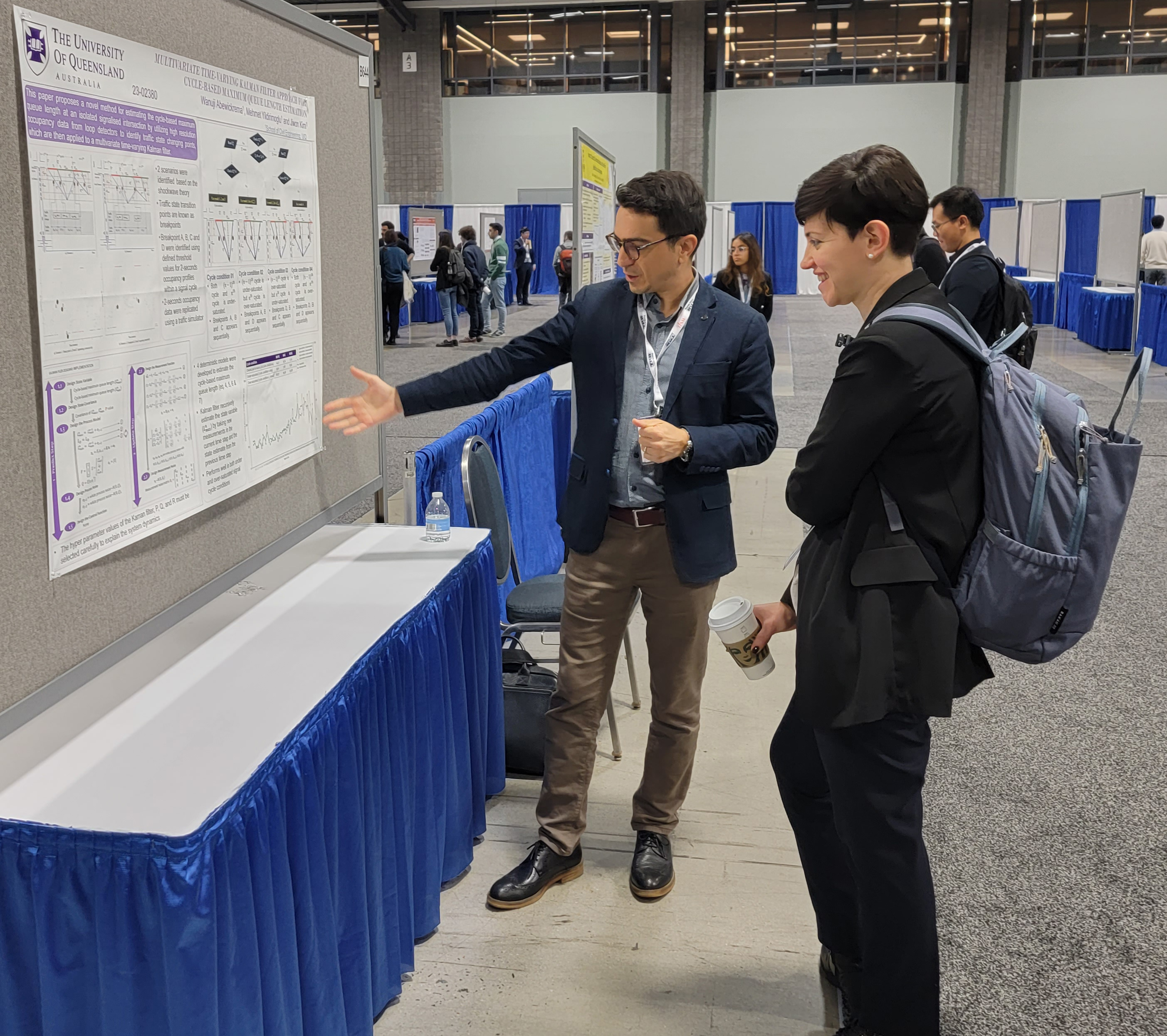 Civil and Environmental Engineering Professor Maria Laura Delle Monache presides at the Traffic Flow Theory, Part 4: Traffic Modeling, Monitoring, and Control session, checking out University of Queensland lecturer Mehmet Yoldirmoglu's poster