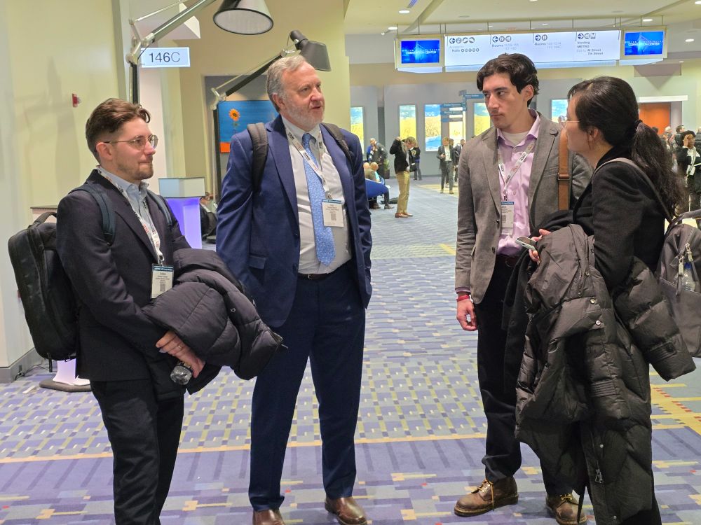 Cristian Poliziani, Thomas Wenzell, James Butler, and Lin Jing hanging out in the hallway