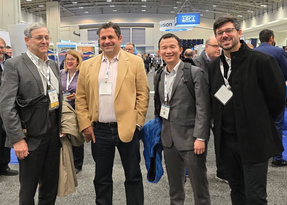 Steven Shladover, James Fishelson, Hao Liu, and Justin Wiley pose at the exhibit hall reception