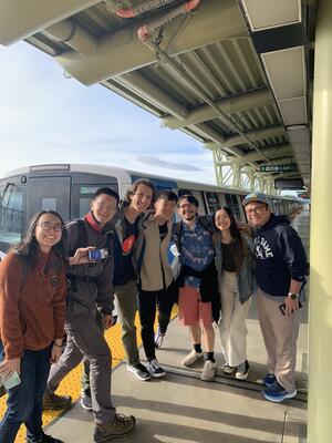  Melody Tsao, Chance Wen, Ameen DaCosta, Paul Liu, Jacob Champlin, Winnie Zhuang, and Mike Santos pose at a BART station before embarking on their Speedrun.
